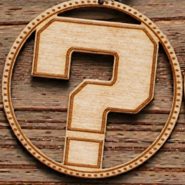 Wooden earrings with question mark design on a wooden surface